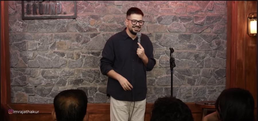 Rajat Thakur on stage, mid-punchline